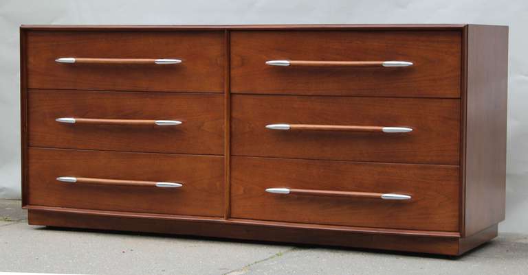 T.H. Robsjohn-Gibbings for Widdicomb six drawer walnut dresser with nickel plated pulls; on casters. Original label intact.