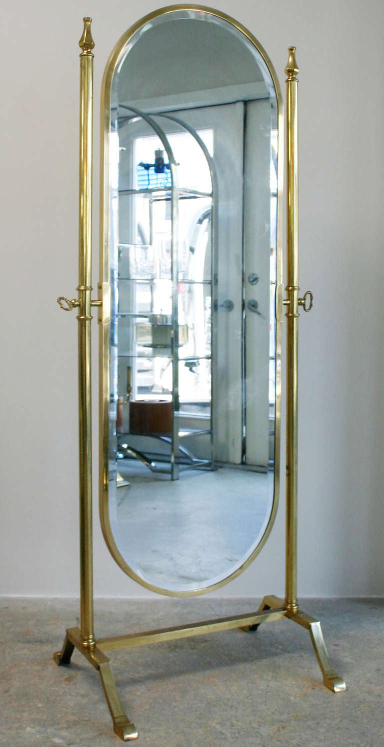Exceptional solid brass pivotal Regency style full-length floor mirror with bevelled mirror.