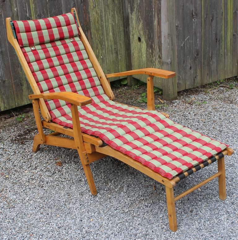 A sensational 1950's reclining and folding wood frame chaise lounge with leather straps and vintage original snap-on upholstery. Compresses to chair size as well. See pictures.

Available for rental. Please inquire.