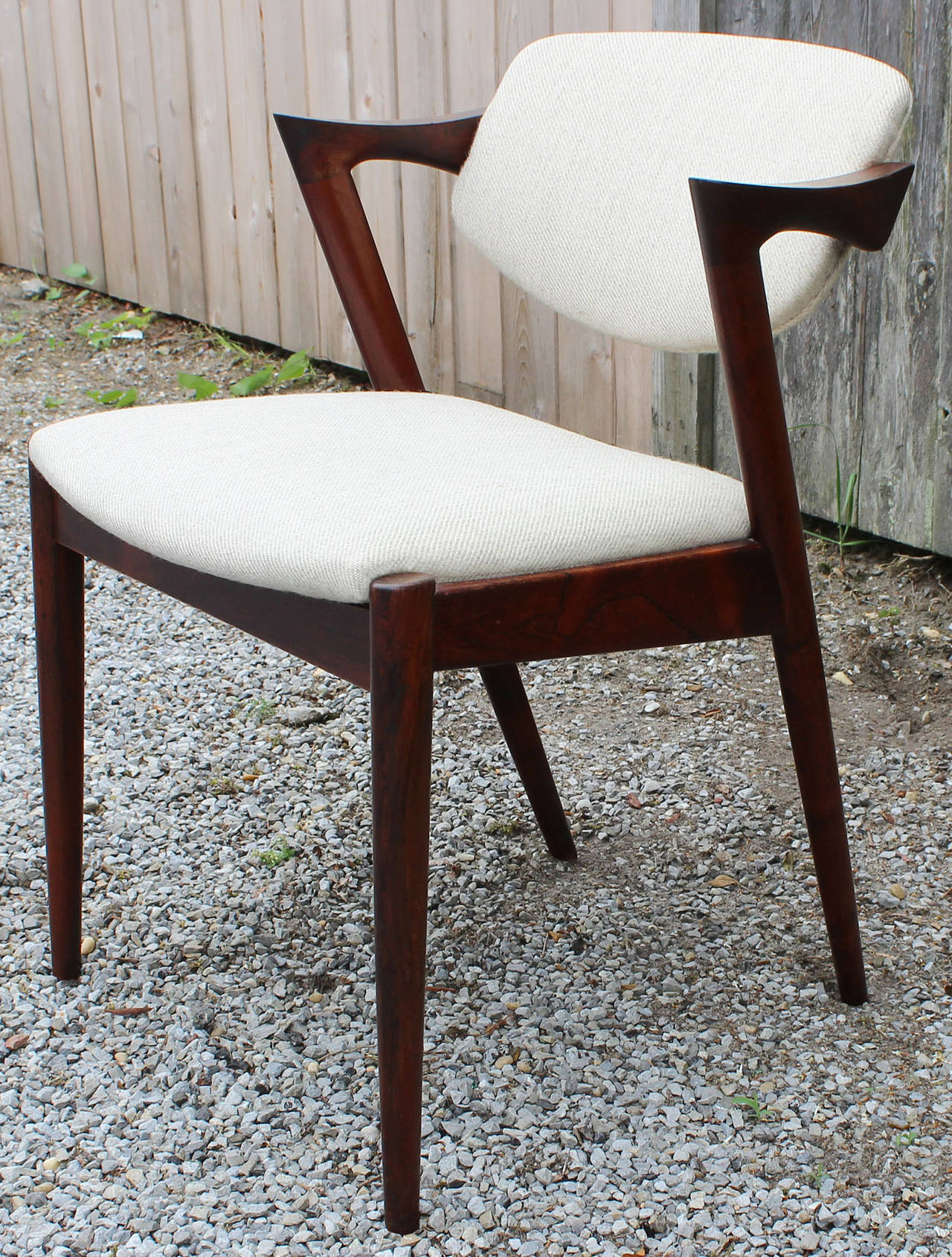 A set of six rosewood model 42 dining chairs with floating swivel backs designed by Kai Kristiansen.

Matching round, book matched rosewood dining table with two large leaves also available see pictures.