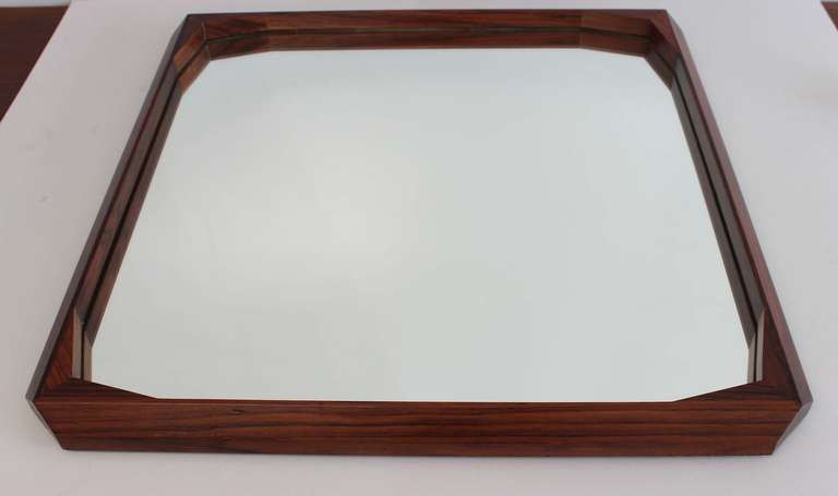 A handsome faceted rosewood frame mirror from Italy.