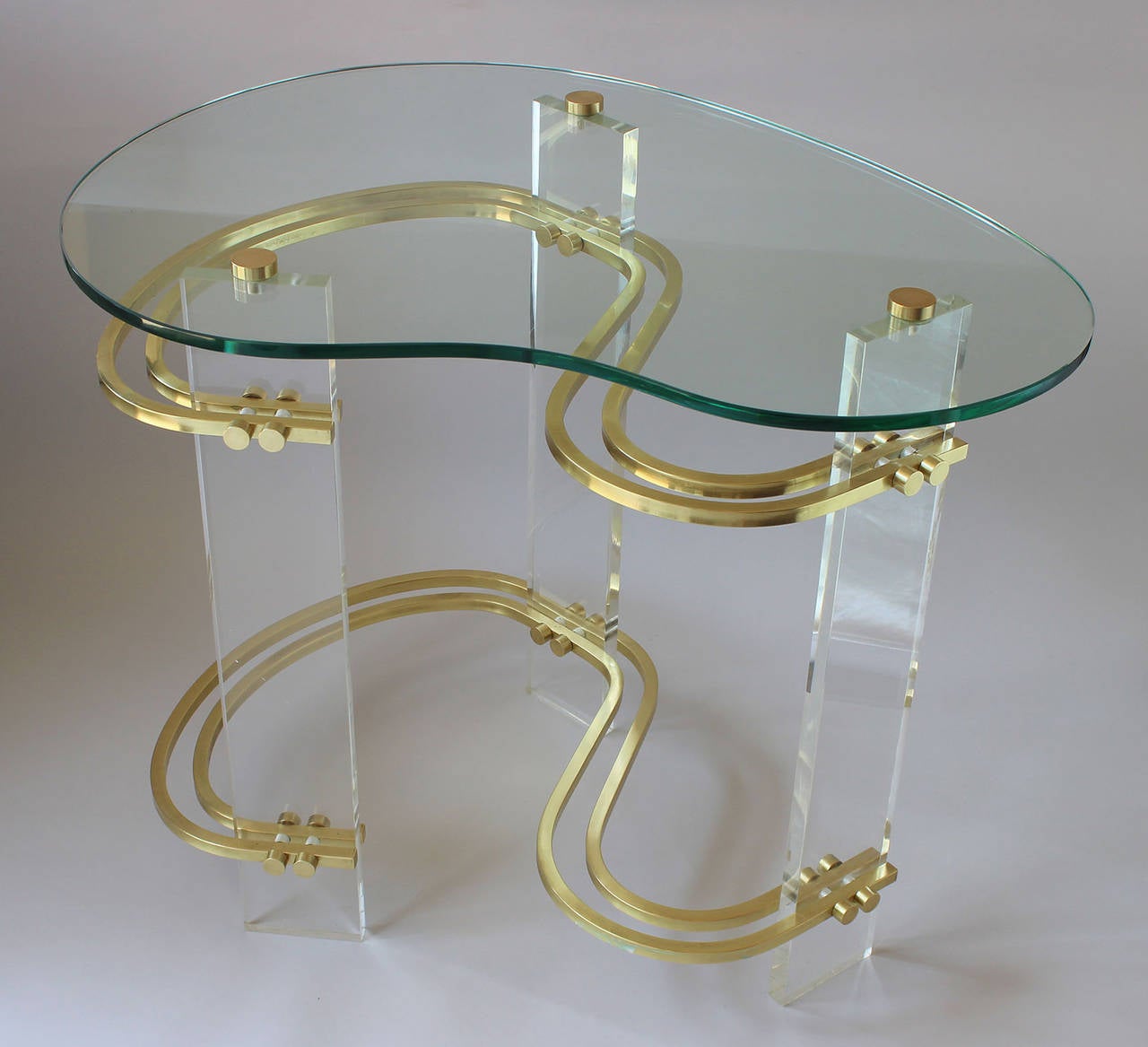 A Magnificent pair of lucite, brass and glass end tables designed by Charles Hollis Jones (b 1945), who founded CHJ Designs in Los Angeles at the age of 16, and received commissions from Frank Sinatra, Lucille Ball and Johnny Carson, among others.