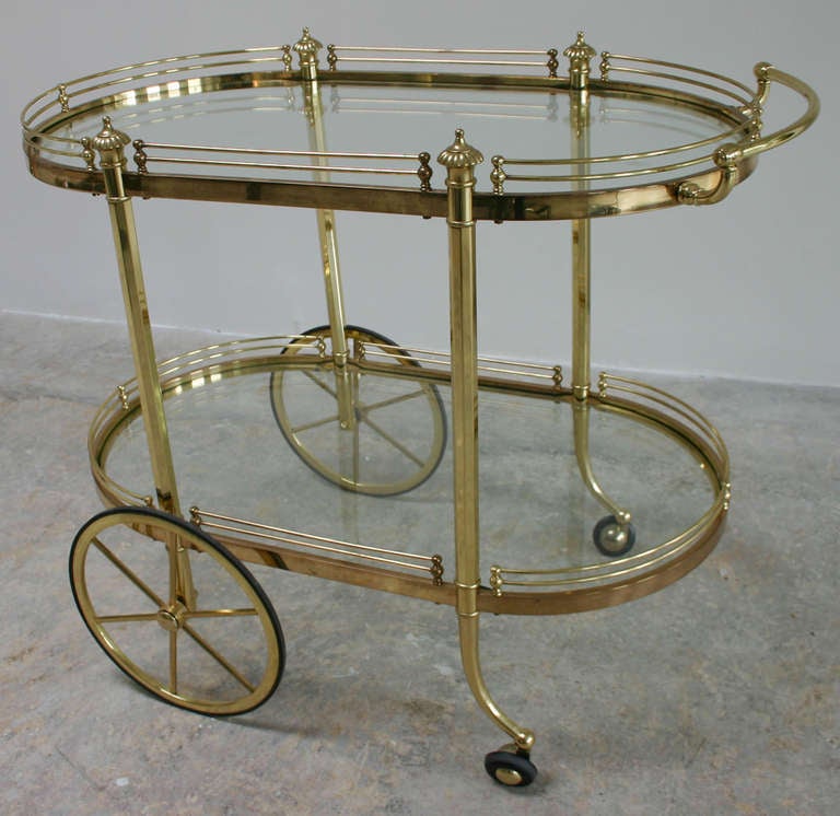 Two-tier Italian Regency style brass and glass rolling bar cart server.
