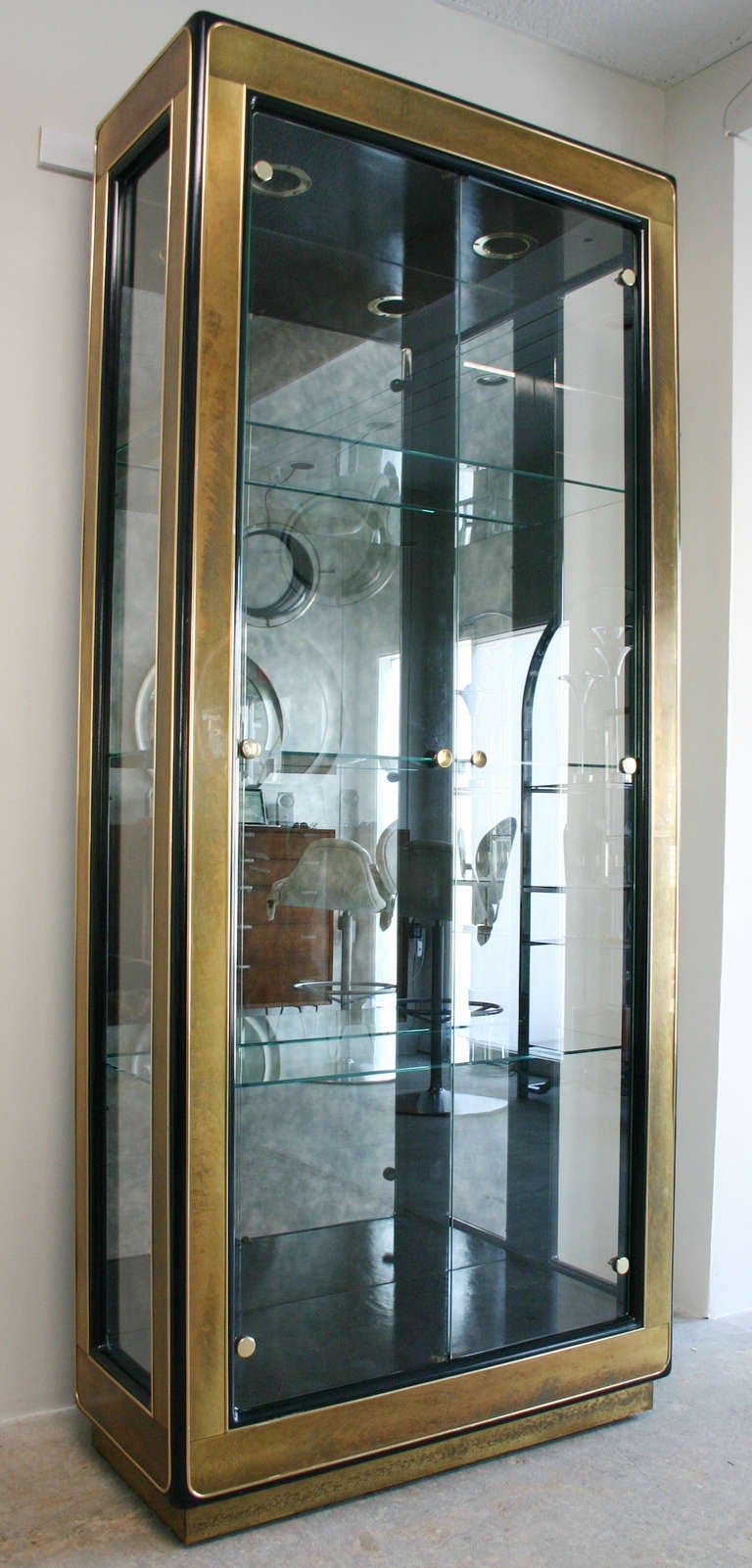 Handsome patinaed brass and glass vitrine cabinet with recessed lighting.