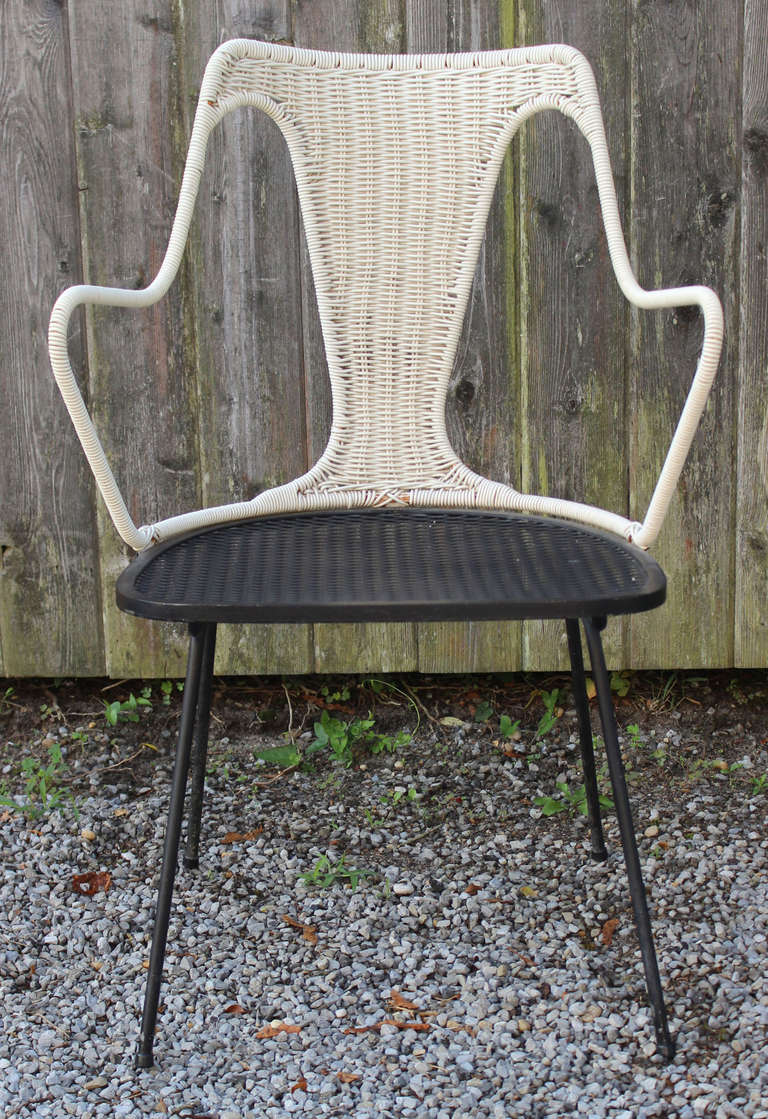 A simply sexy set of eight iron mesh and woven rattan and vinyl dining or garden chairs with vintage cushions by Maurizio Tempestini for Salterini.

seat height 18.5