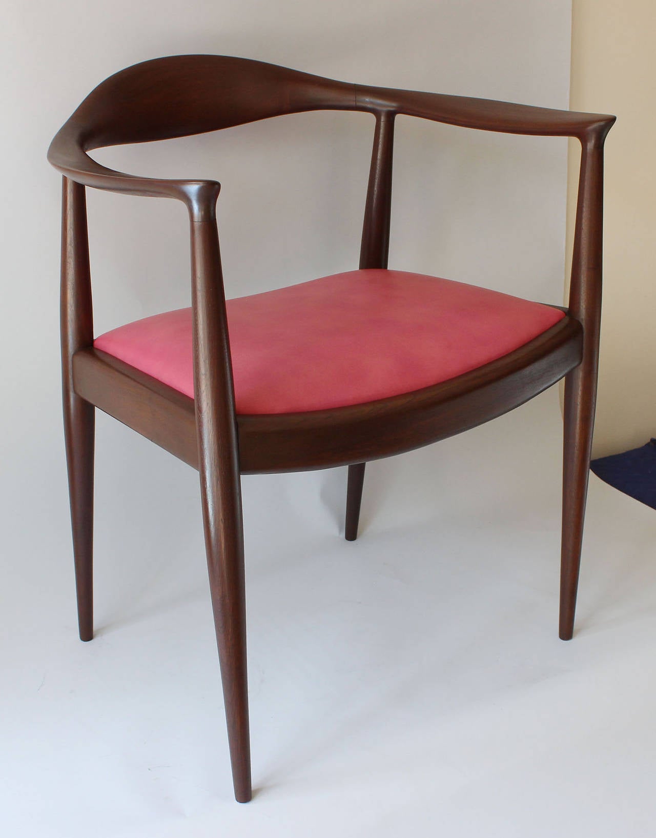 Classic teak armchair with red leather seat, designed in 1949 by Hans Wegner in collaboration with furniture maker Johannes Hansen.  It rose to prominence in the 1961 televised debate between Richard Nixon and John F. Kennedy. Both presidential