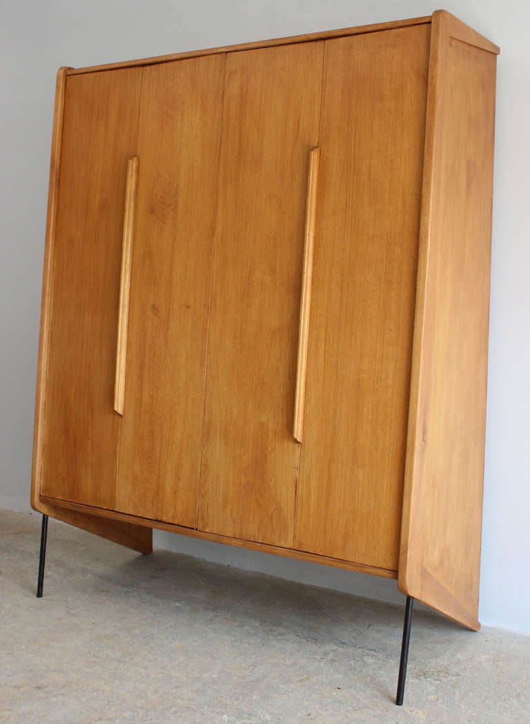 A handsome modern French beech wood wardrobe cabinet with interior shelves and hooks, design attributed to Claude Vassal.