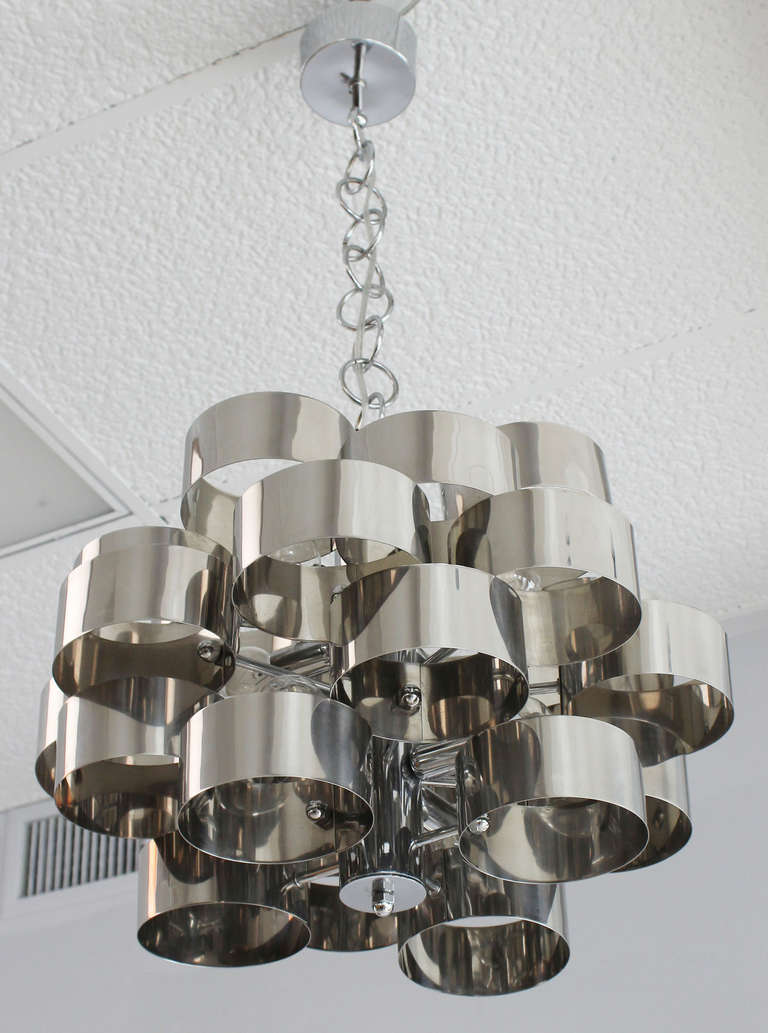 A 1970s chrome band loop chandelier in the manner of Gaetano Sciolari.<br />
6