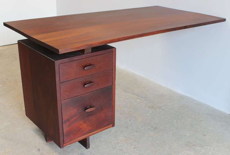 An all wood, wall-mounted cantilever desk with three drawers, in the manner of George Nakashima.

drawer unit measures 16