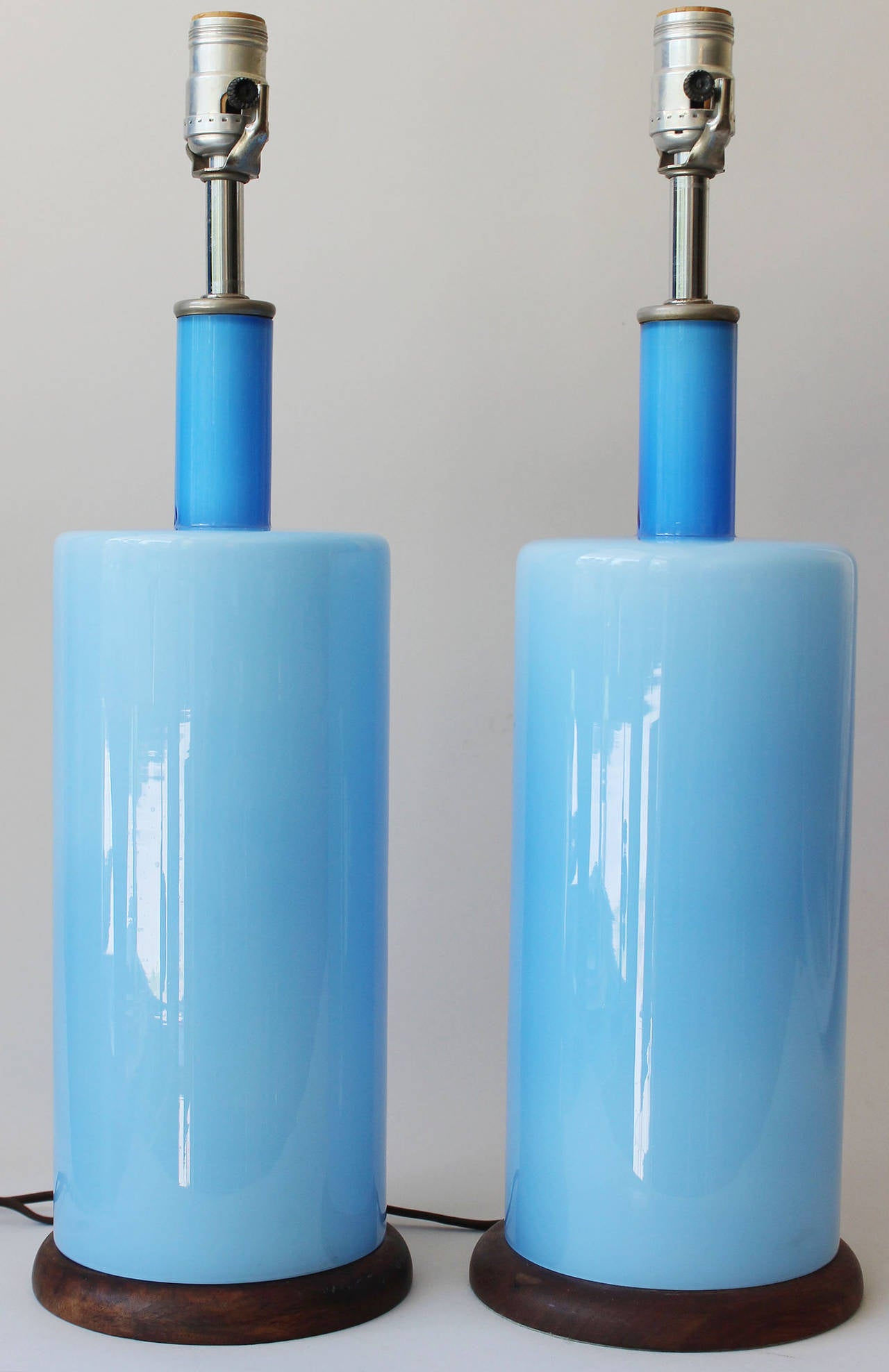 Georgeous Holmegaard style cerulean blue cased glass lamps with teak bases.

Height is to the bottom of the socket.
