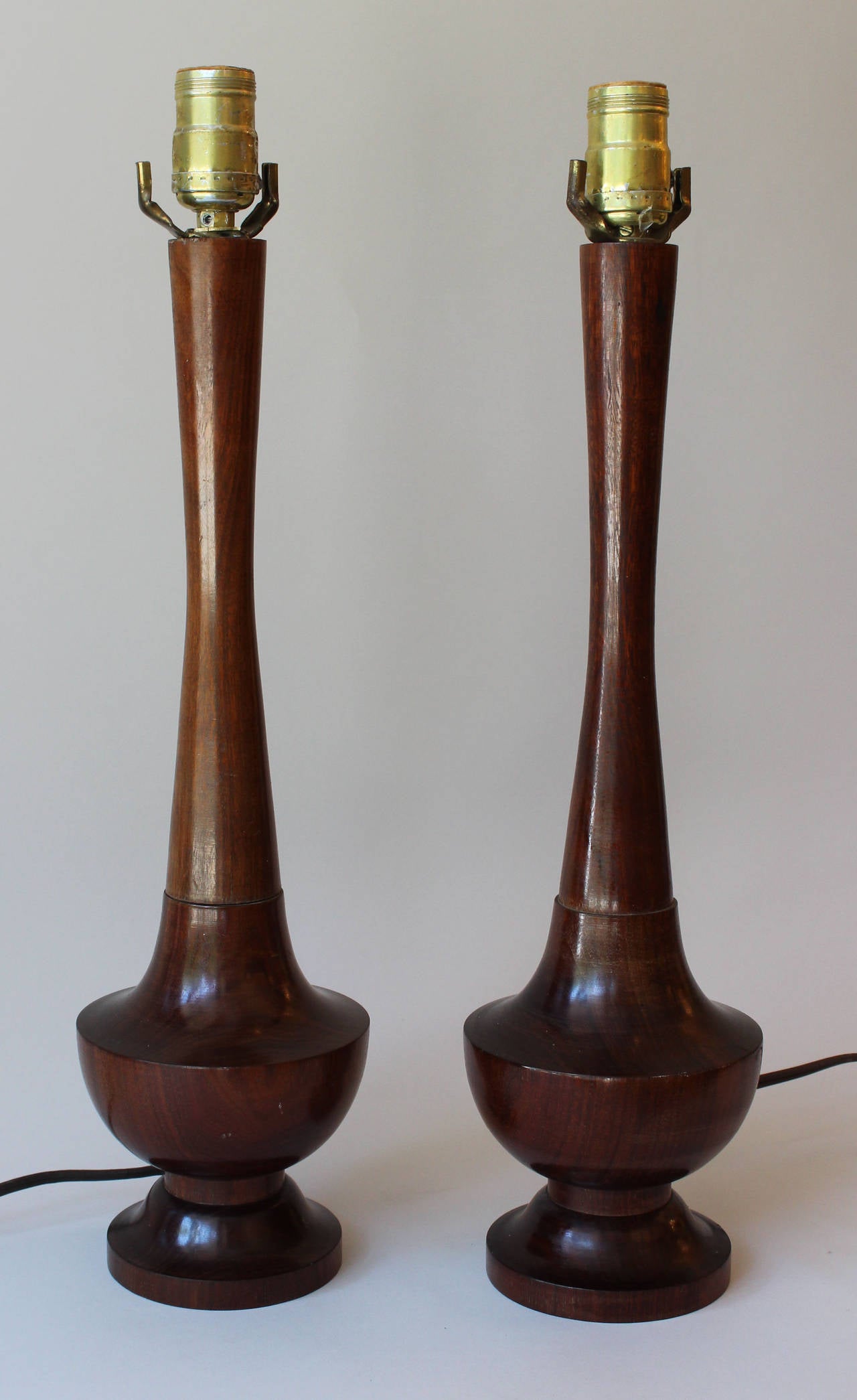 A pair of dark walnut stained solid walnut turned lamps.

Height is to bottom of socket.