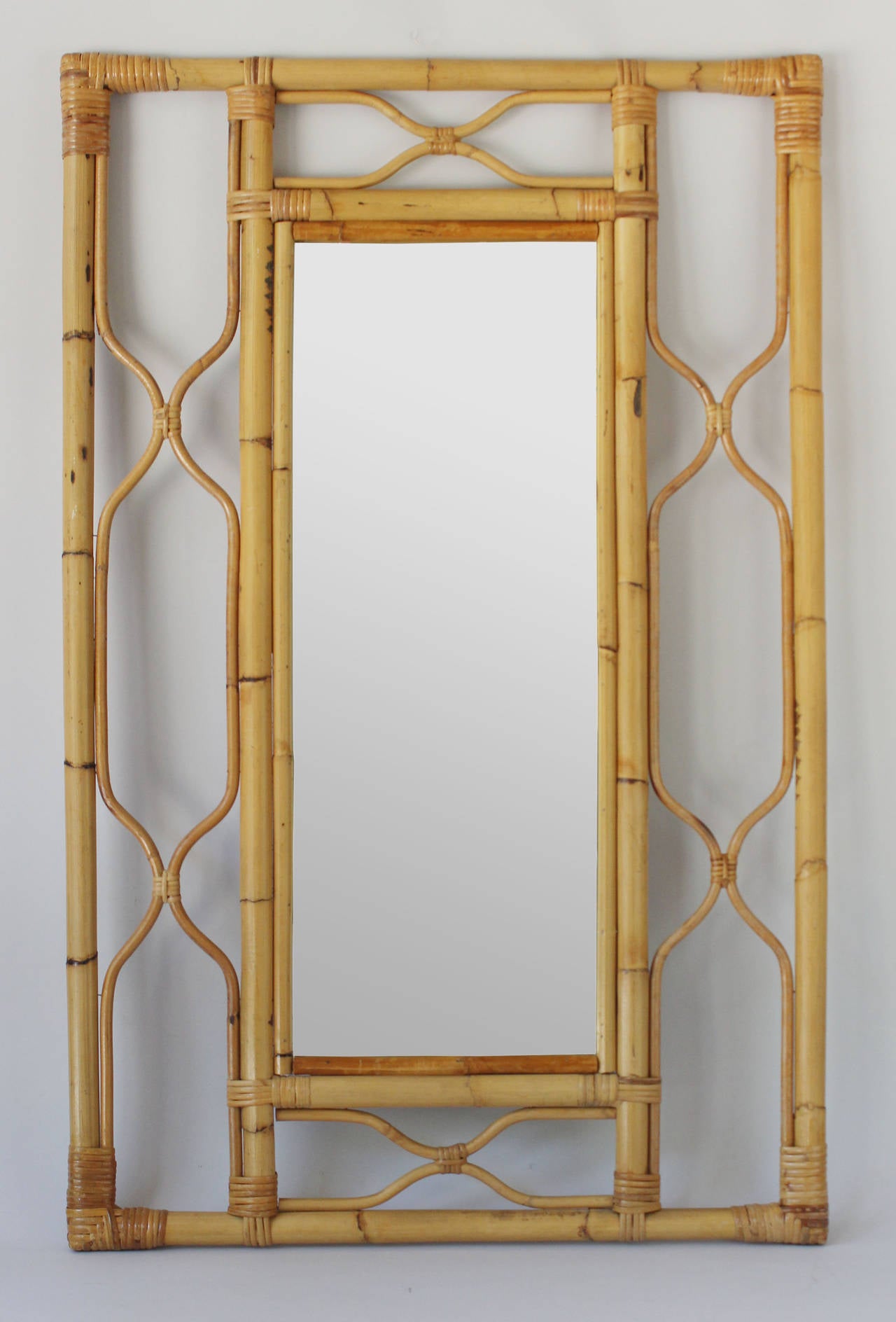 A regency style bamboo and rattan frame mirror with decorative margins.

complementary delivery within 30 miles / Hamptons