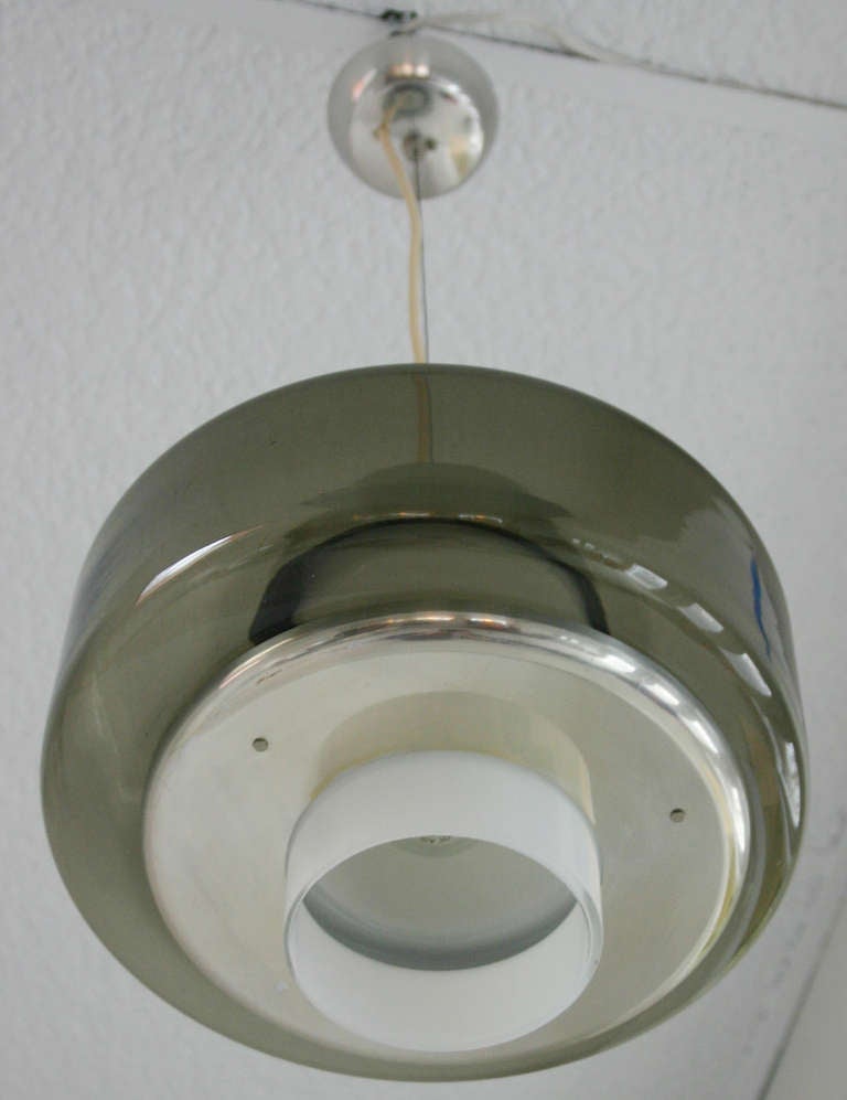 Industrial style Italian smoke glass and metal pendant with tubular milk glass diffuser.