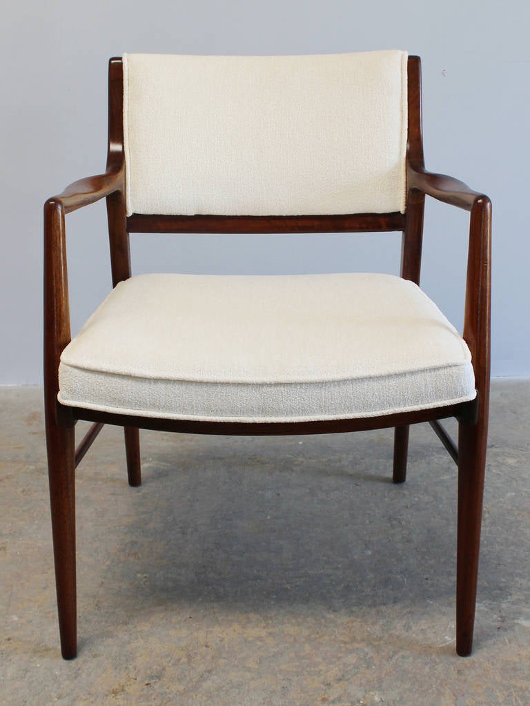 A pair of newly restored and upholstered solid walnut armchairs, designed by Jens Risom.