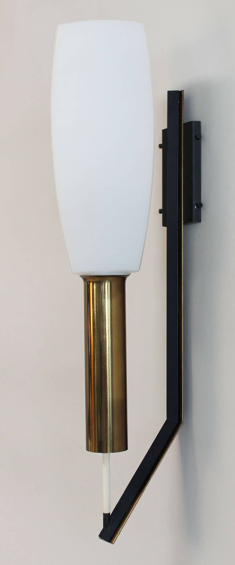 A handsome pair of triangular milk glass and enameled brass sconces with brass details. Three available.
