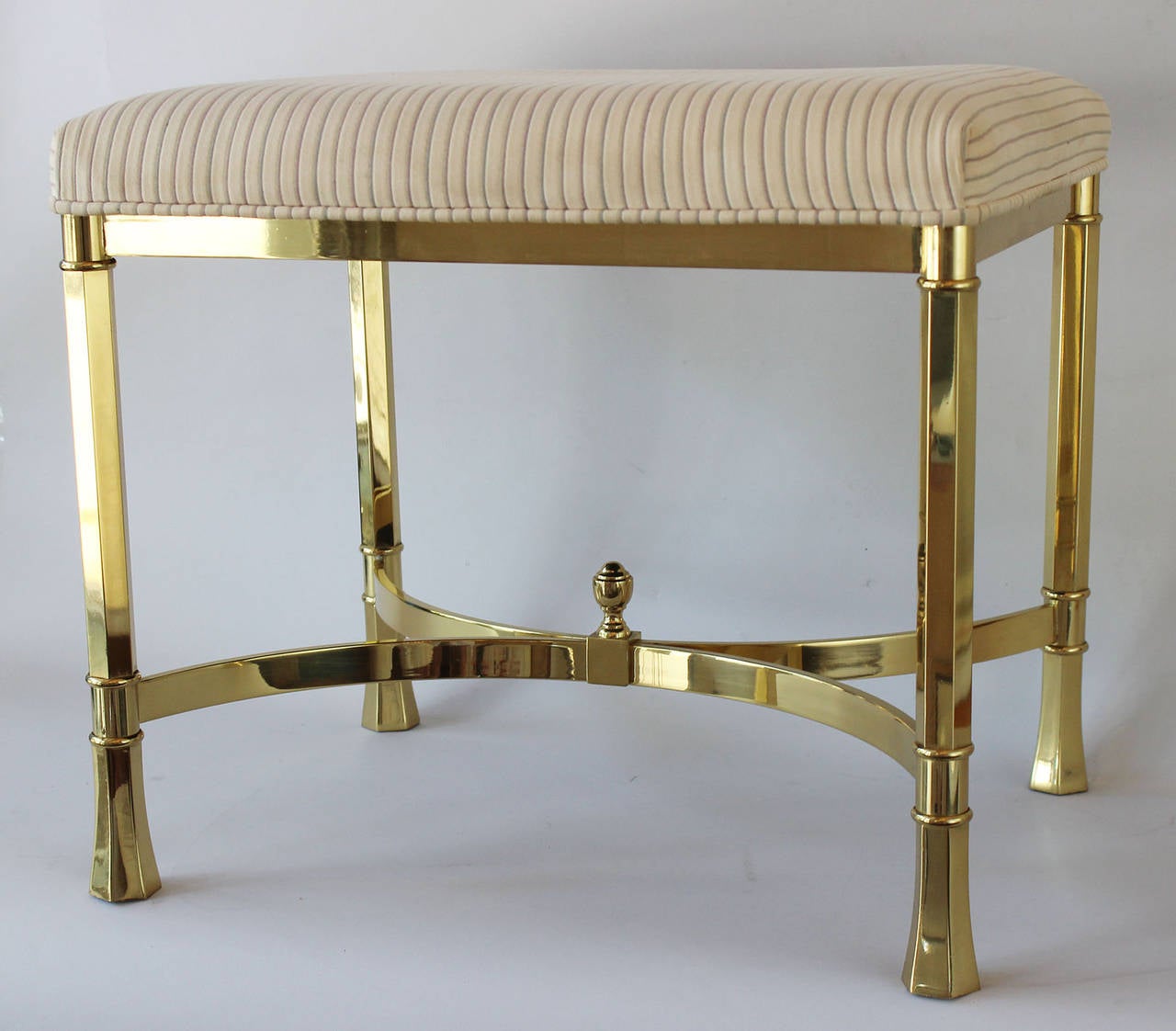 A very solid pair of Regency style brass ottomans in vintage upholstery.

complementary shipping within 30 miles