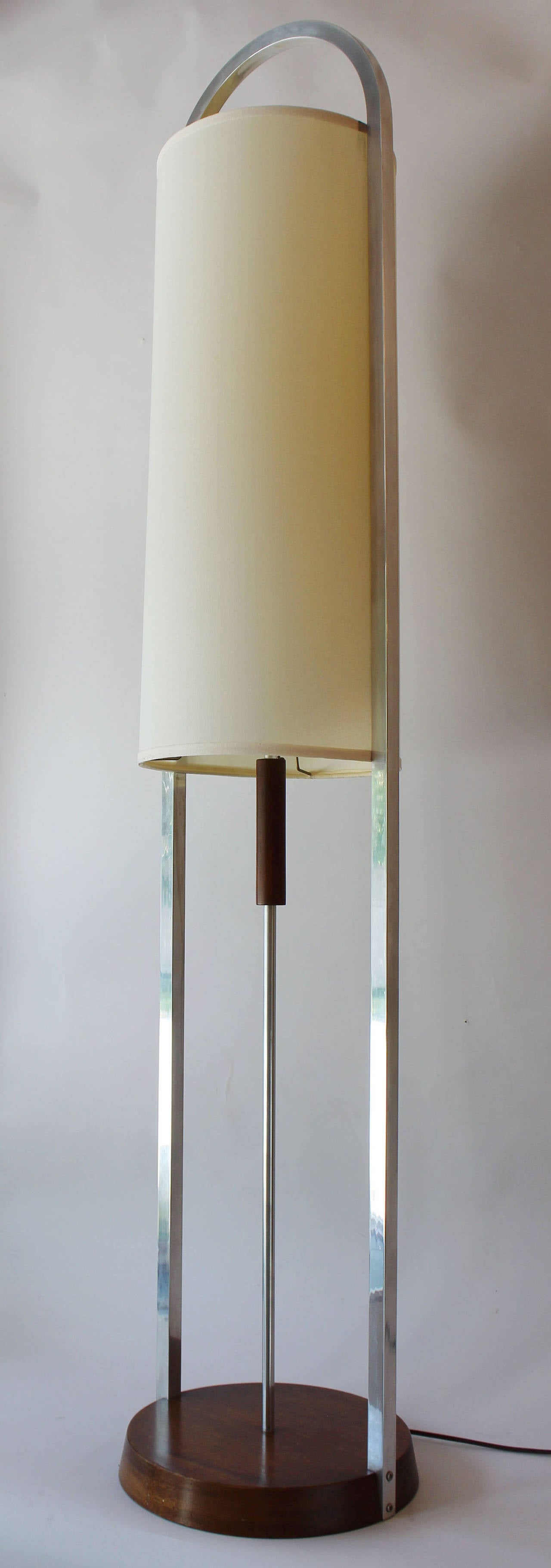A walnut and aluminum floor lamp with cloth shade by Modeline.