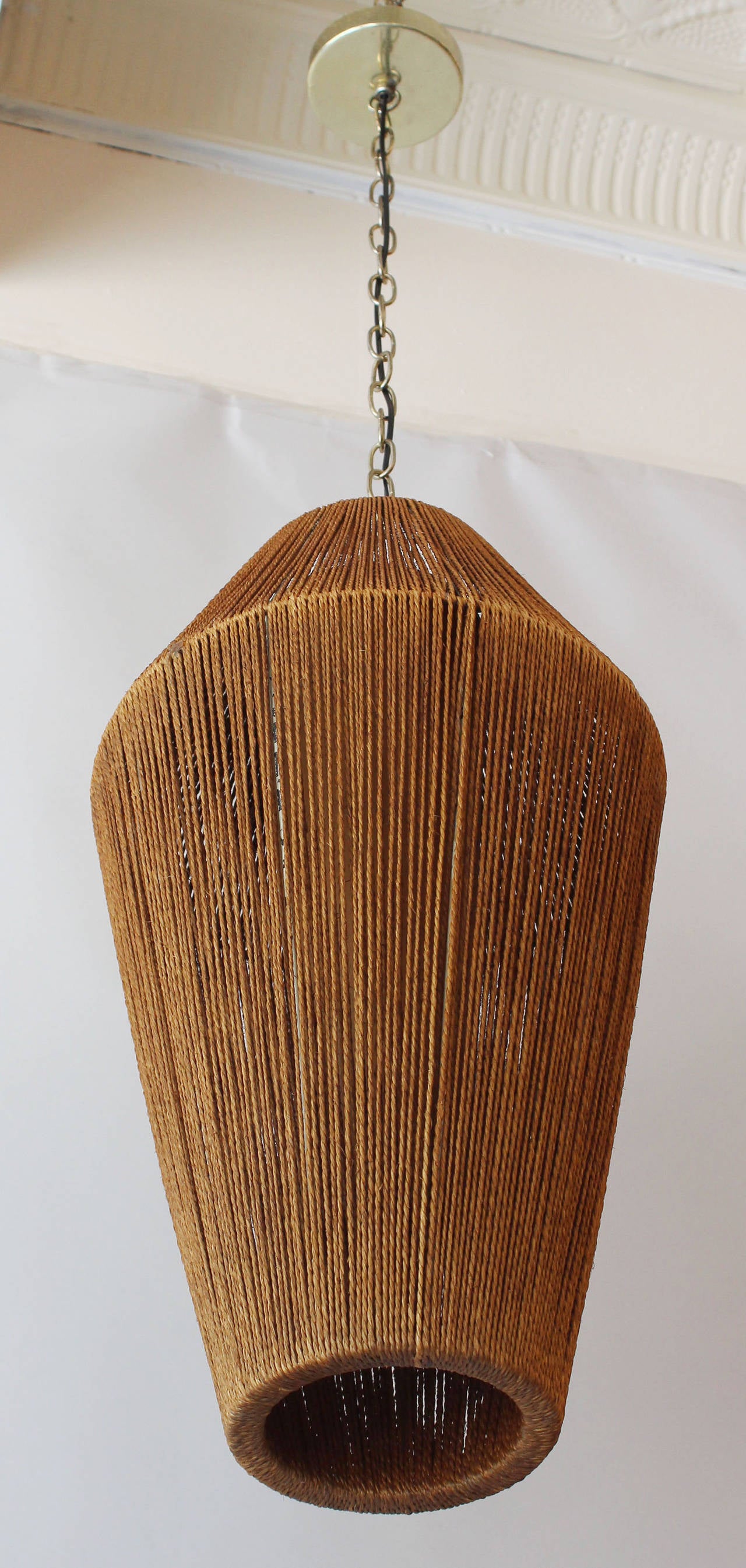 A metal and jute cord pendant with interior diffuser by Fog and Morup.