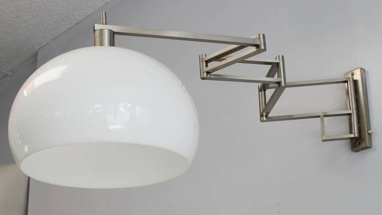 Architectural chic perspex and brushed steel retractable wall light by Reggiani.

Shade 10