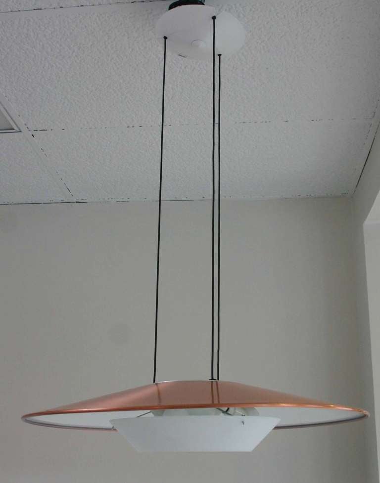 Copper color spun aluminum pendant with metal diffuser. Lights up and down. labeled Foscarini Murano Italy.