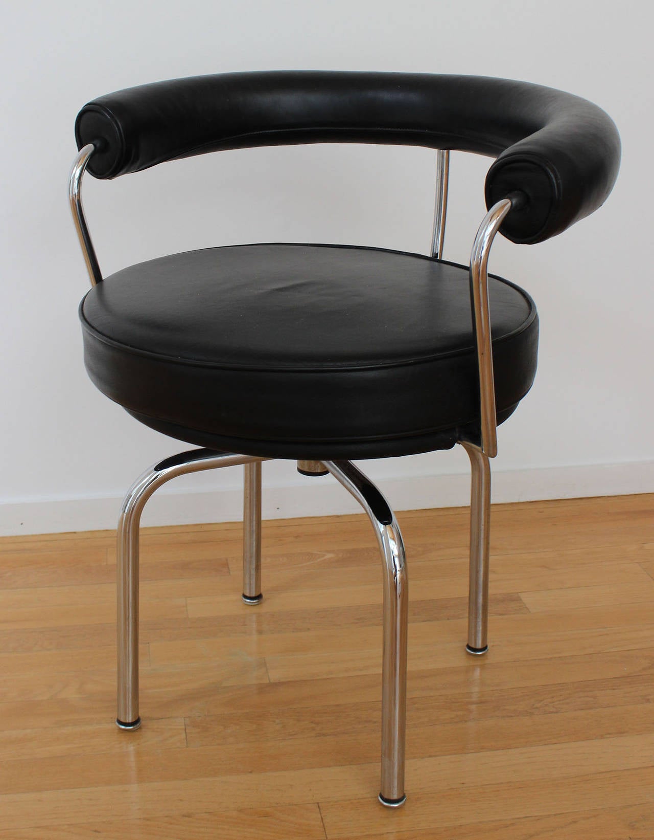 Iconic tubular chrome and black leather LC7 chairs designed by Pierre Jeanneret, Charlotte Perriand and Le Corbusier for Cassina.

Complimentary shipping within 30 miles of Southampton NY.