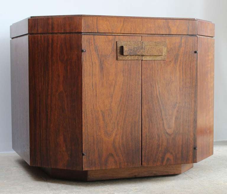 A pair of walnut veneer octagonal end tables or cabinets with patinaed brass handles, in the manner of Harvey Probber.