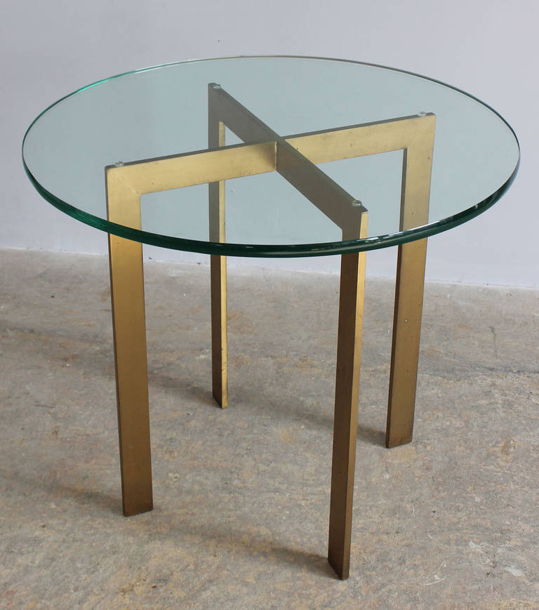An X base side, end or occasional table with 3/4 inch bevelled glass top in the manner of Mies van der Rohe.