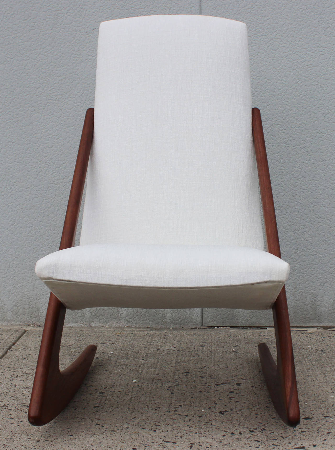 Fabulous teak frame boomerang rocking chair newly upholstered; by Mogens Kold Mobelfabrik, Denmark.

Complementary shipping within 30 miles.