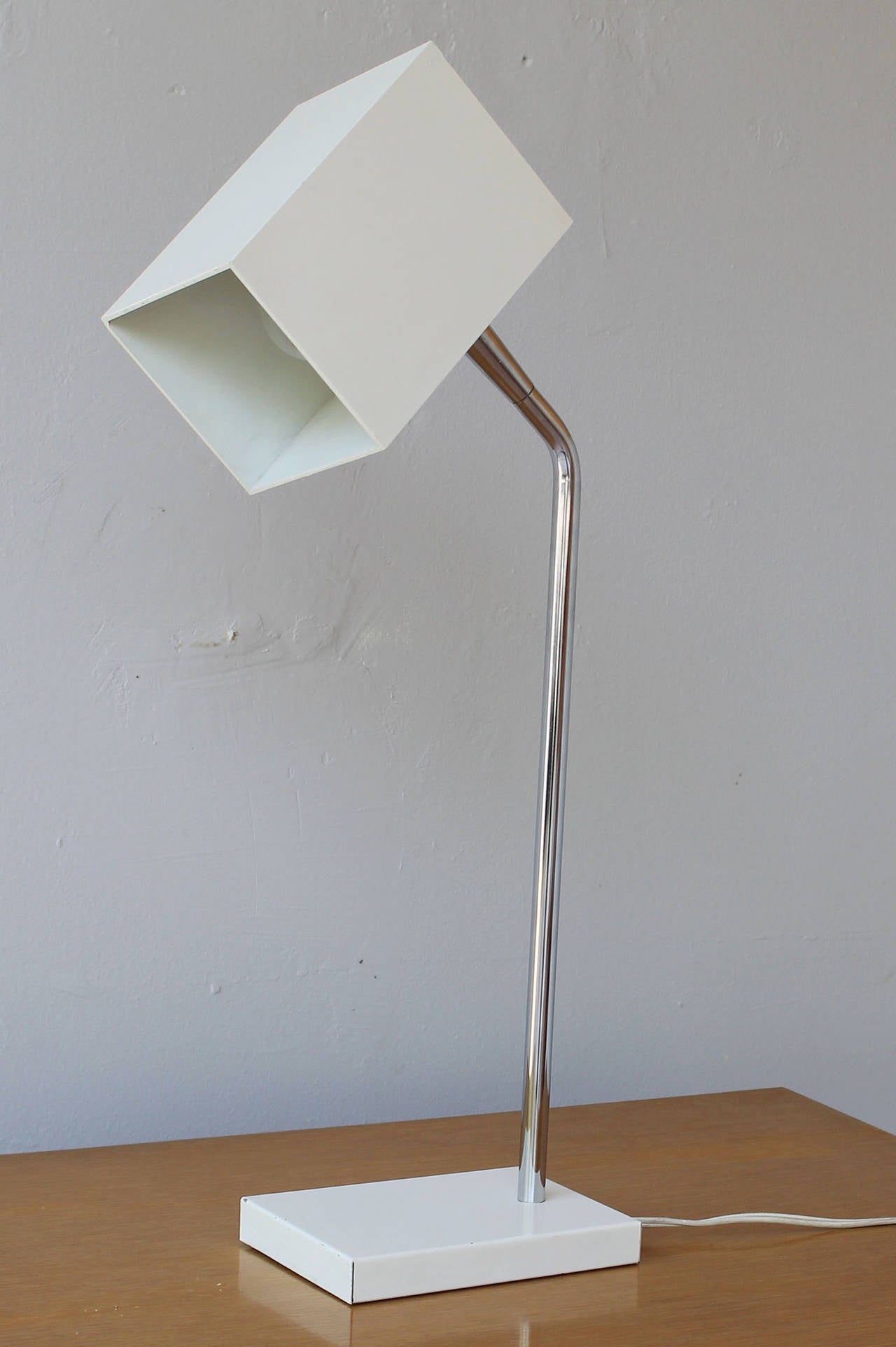 An early articulating chrome and enameled metal desk lamp by Robert Sonneman for Kovacs.