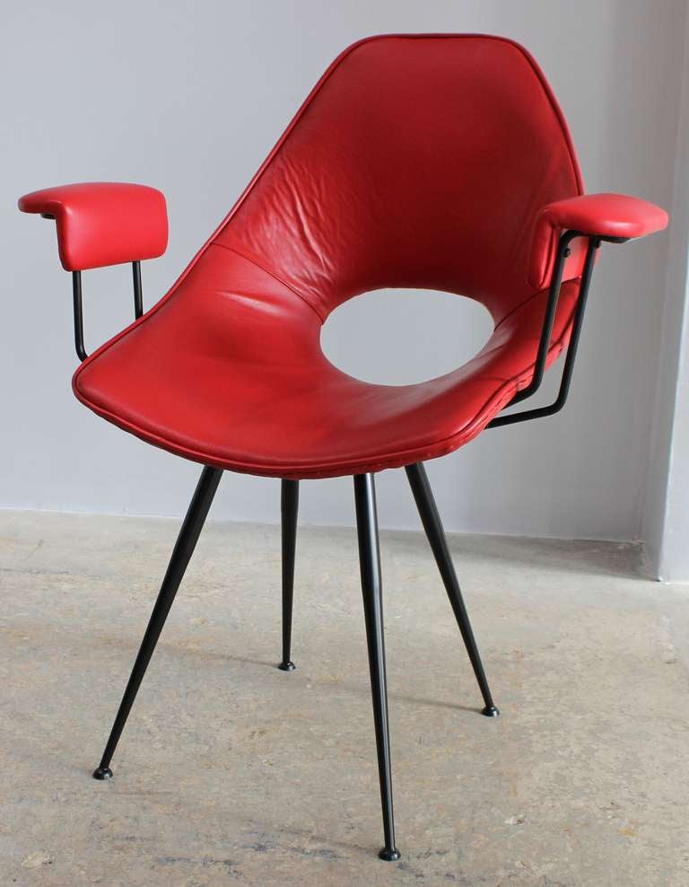 Sculptural black metal arm or desk chair reupholstered in bright red leather, attributed to Gaston Rinaldi for Rima.