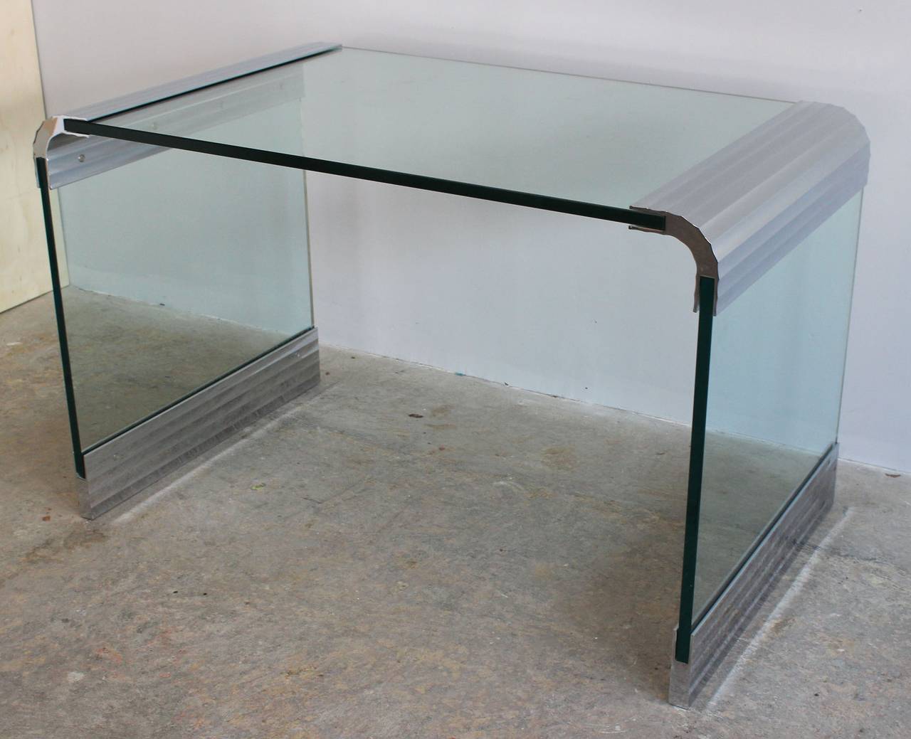 A Pace Collection 1/2 thick glass desk or writing table with ribbed, nickel plated hardware.