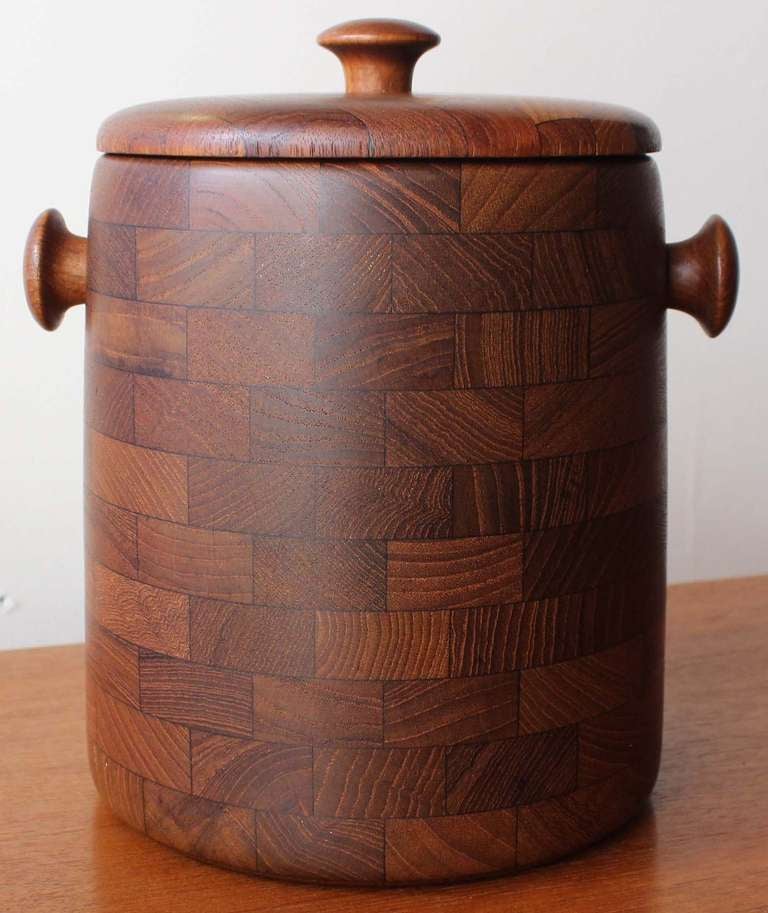 Teak end grain ice bucket with white plastic interior.