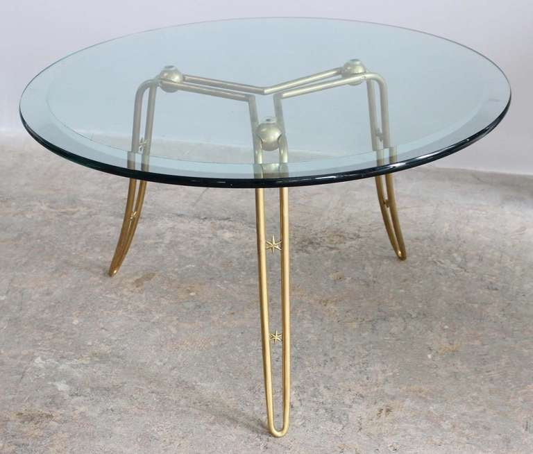 Solid brass table with star details and glass top.