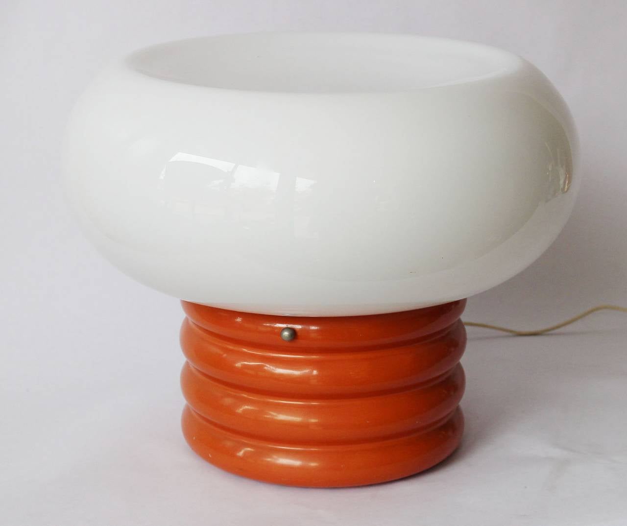 A sculptural, molded milk glass and enameled metal lamp.

one socket -- up to 75 watts.