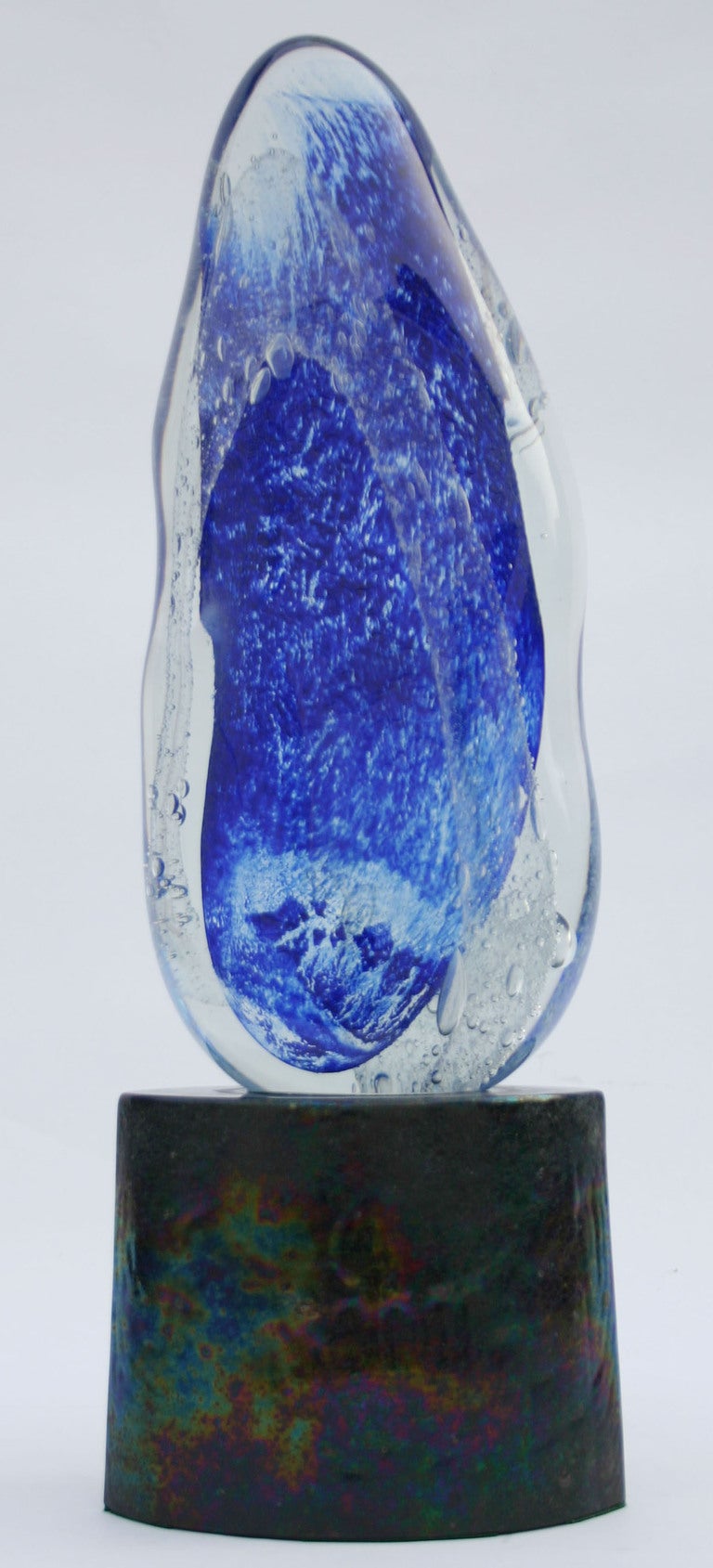 Brilliant blue and clear Murano unique glass sculpture on black cast glass base.