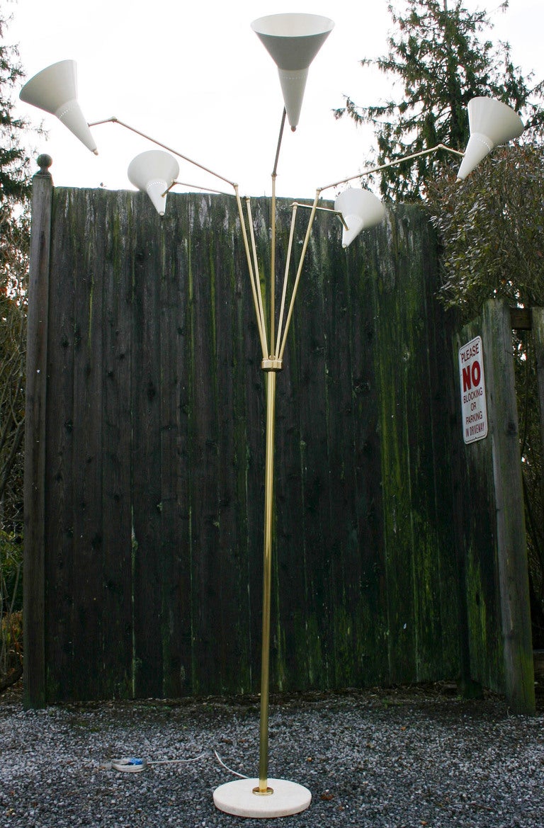 Gorgeous multi-directional 1950s style satin brass floor lamp with enameled brass shades on a travertine marble base. Obtains great height. New wiring.