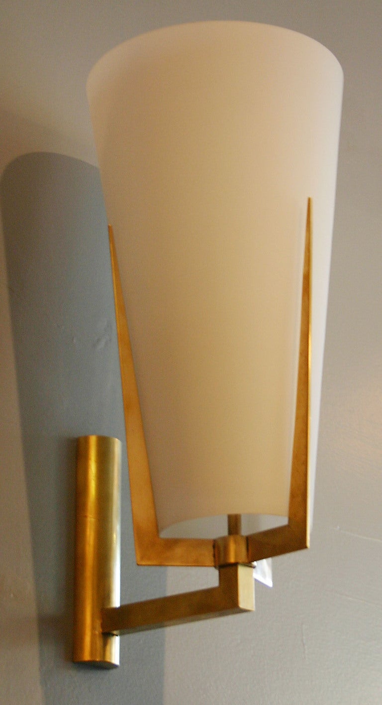 Exceptional pair of Italian brass and milk glass sconces in the manner of Stilnovo.