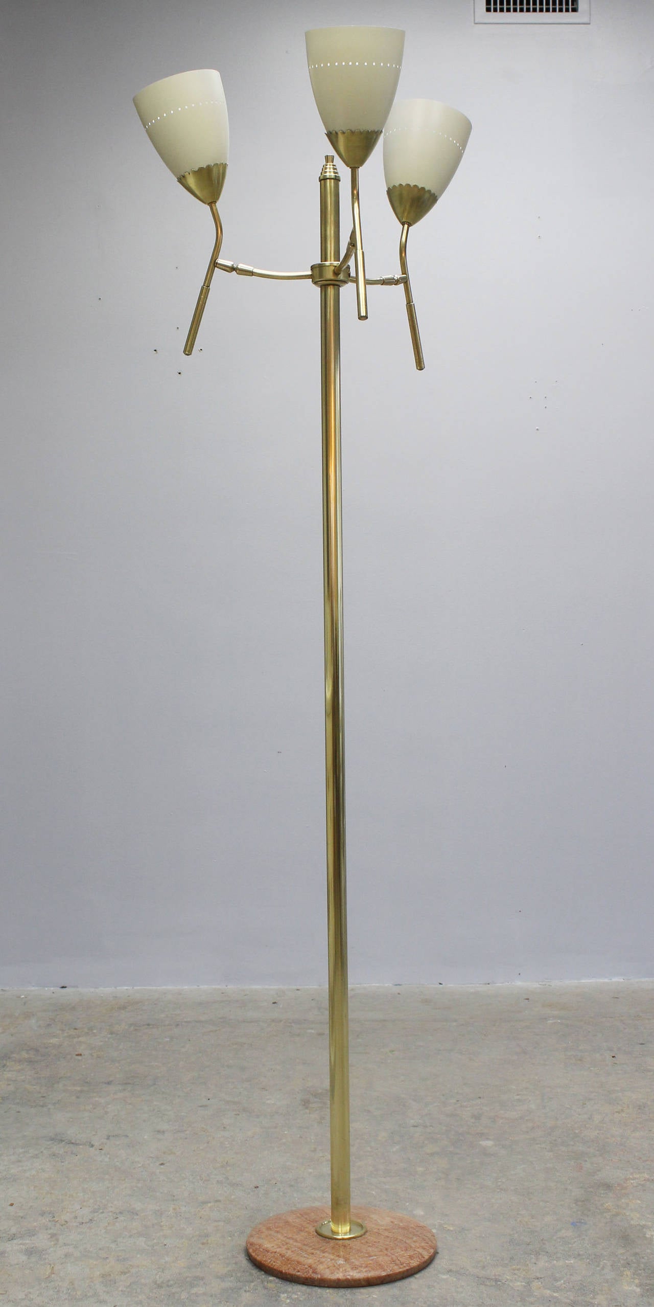 An Italian three-head brass floor lamp with 12 inch marble base and enameled metal shades, in the manner of Arredoluce.