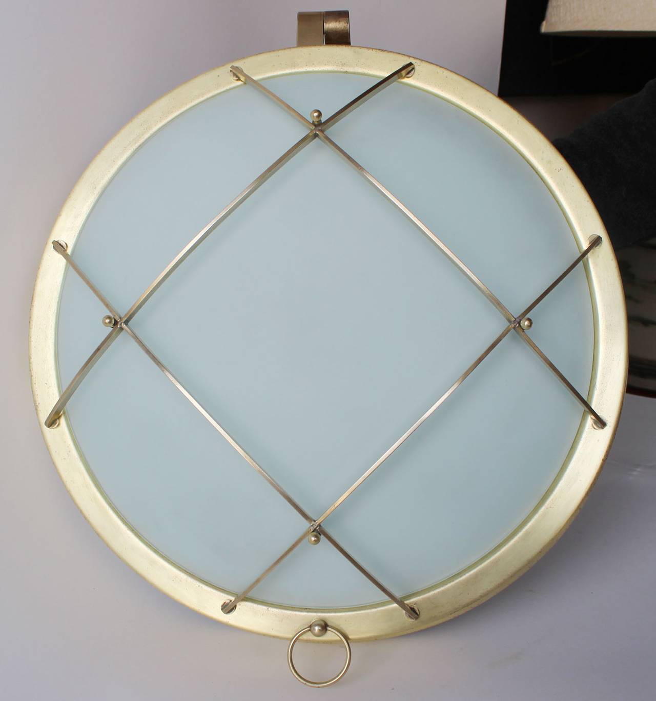 An early Industrial modern porthole style flush mount ceiling or wall light, with convex, acid-etched glass and three sockets.