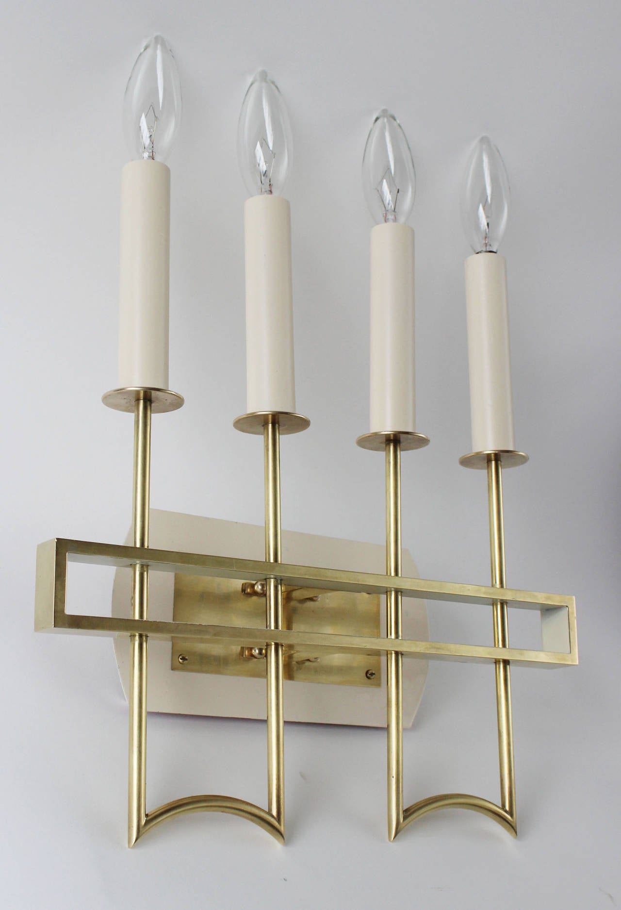 A beautiful pair of solid and tubular brass sconces with enameled wood candles, in the manner of Arredoluce.