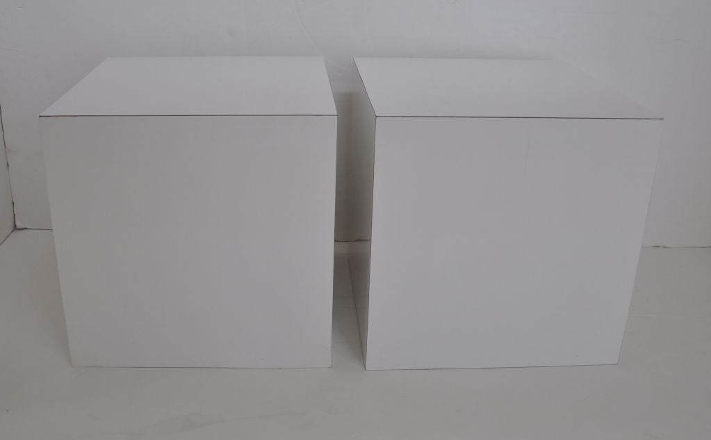 Pair of square cubes in white laminate.