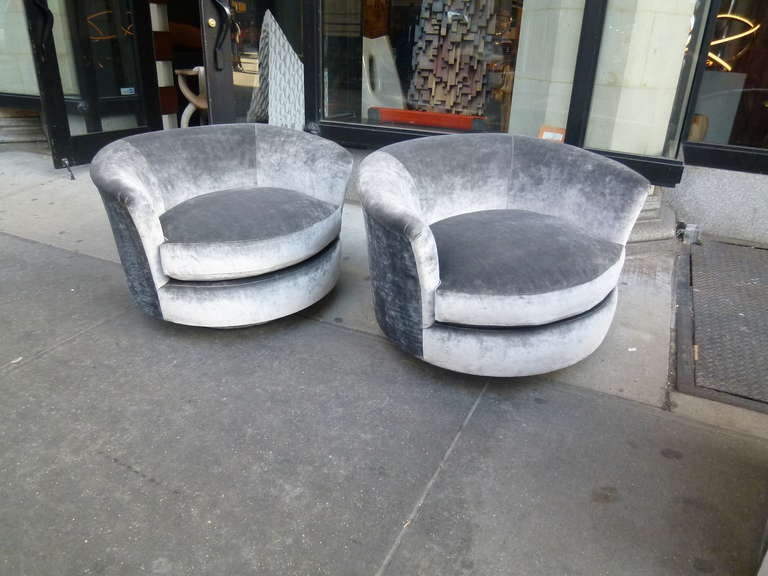 A pair of swivel demi-lune chairs designed by Milo Baughman for Thayer Coggins. Each has a circular chrome base that swivels with ease. Newly upholstered in  Romo Orbit Tungsten Silk Velvet.

Excellent condition.

Dimensions: 24”H  x 35” W x 33”D