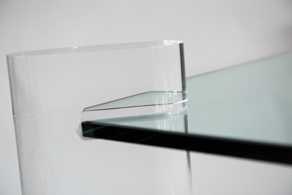 This rare Karl Springer low table comprised of a single piece of polished 3/4" glass held in four corners by custom plexiglass legs. The legs are cut from 3" thick plexi with a gorgeous bullnose Silhouette. This piece is simple, elegant