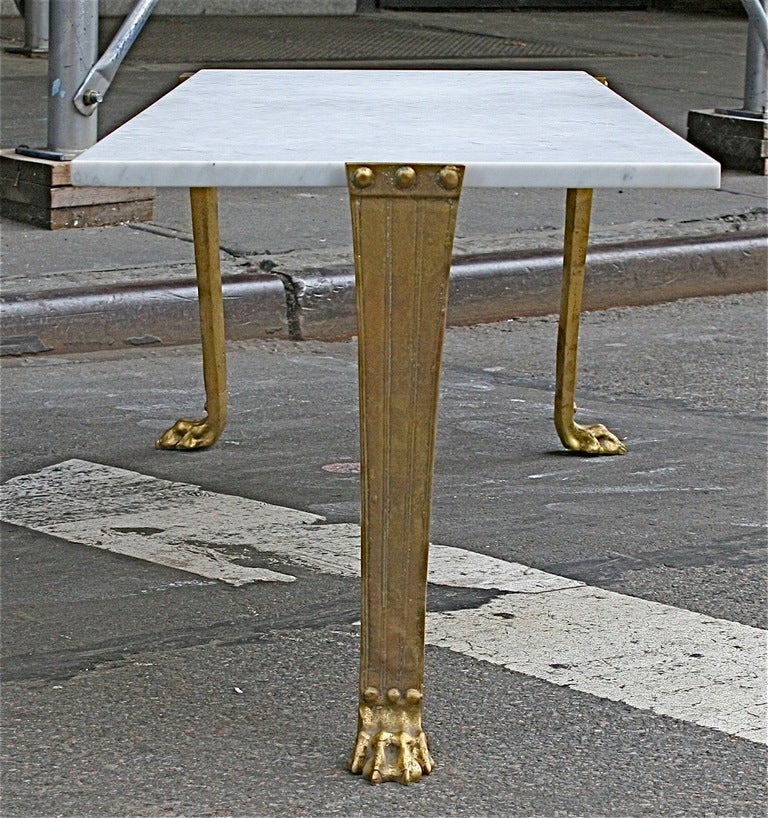 An exceptional custom Trapeza low-table custom ordered with a long marble top produced by Saridis of Athens for T.H. Robsjohn-Gibbings in 1963. The solid bronze cast legs show beautiful patina and appropriate wear. Overall excellent vintage