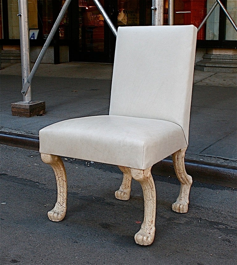 John Dickinson's legendary Etruscan Chair is newly upholstered in parchment leather with wooden legs in an ivory craquelure finish. This is Dickinson's original finish. The Etruscan chair is a reinterpretation of of the Georgian claw-foot chair from