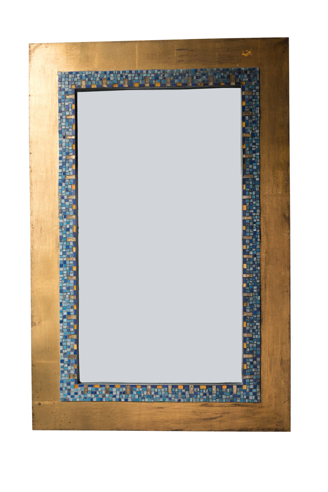 This oversize frame and mirror features a blue glass and gold gilt tile surrounded by a border of gold metal leaf. It is either of French or Italian origin, from the late 1940s-early 1950s. It is in very good condition.

 
Materials: Glass tile,