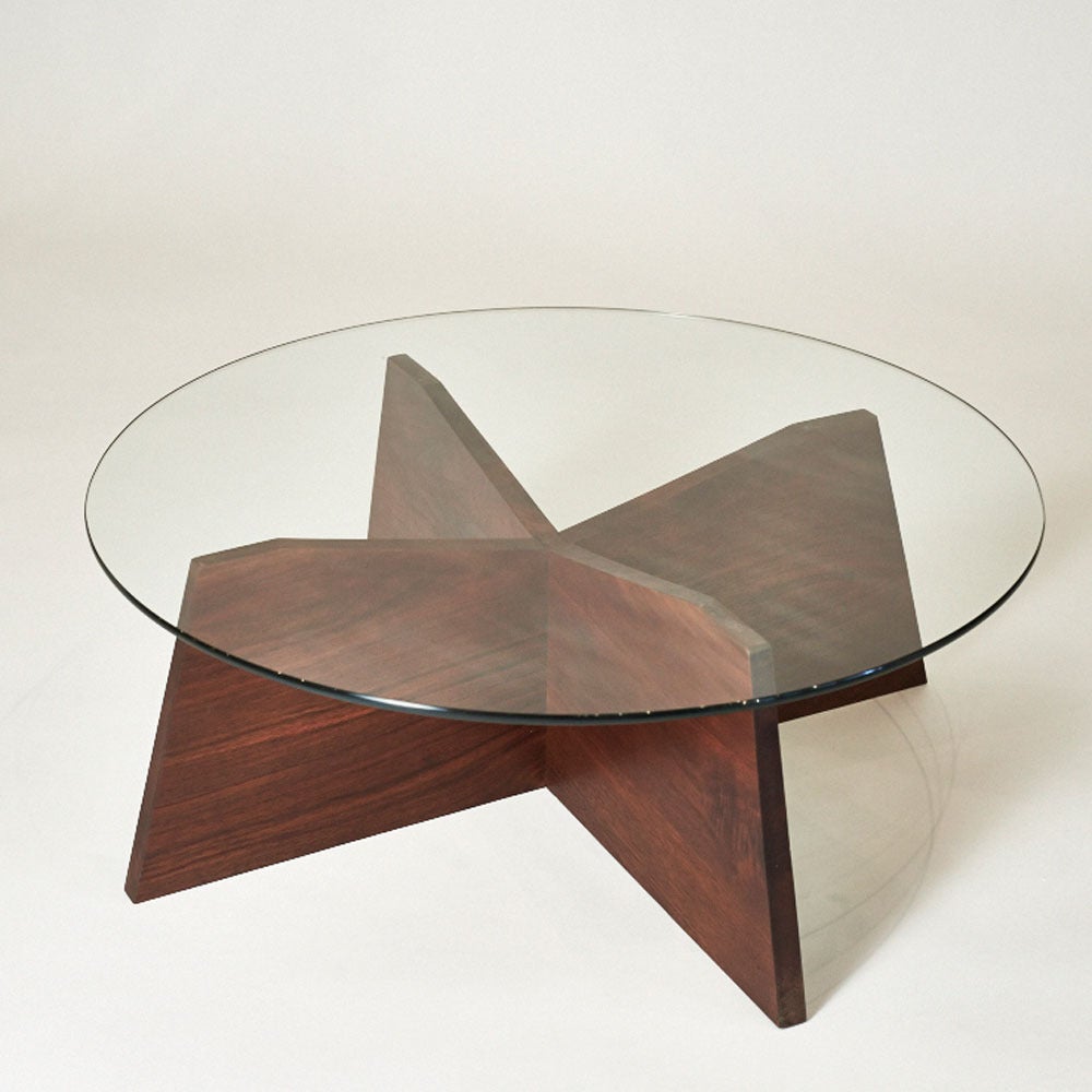A beautiful walnut butterfly-like base and round glass top. Each 