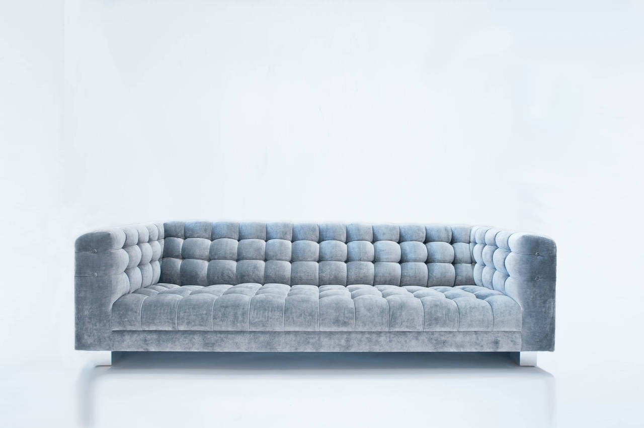 An exquisite 8ft long floating sofa in the Cityscape style. This piece has been newly filled and upholstered in a tufted silver grey Romo sueded velvet. The sofa is suspended on chrome channeled plinths. Upholstery tag, Paul Evans Inc.,