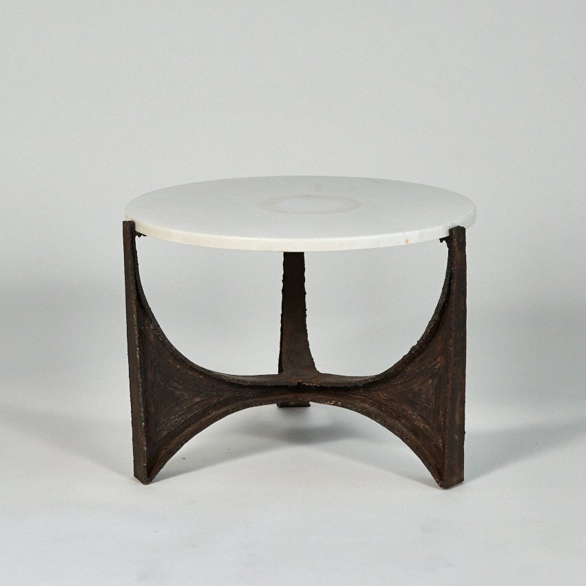 A rare welded and forged steel cocktail table by Paul Evans made in his studio at Aquetong road in the mid-1960s. The heavy steel frame has an extremely graceful form and is decorated with patinated enamel and a welded relief design. The table comes