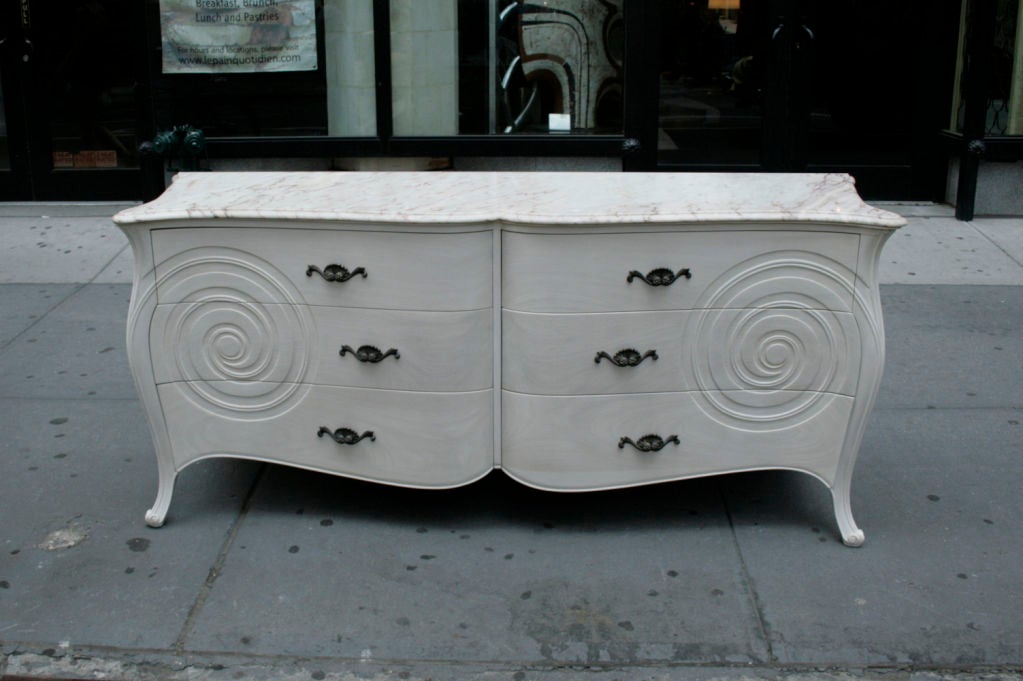 Oversized Six Drawer Marble-Top Dresser by Grosfeld House in the manner of Syrie Maugham, USA, c. 1940s. A bleached mahogany marble-top console or dresser by Grosfeld House. This six drawer case piece features a serpentine bowed front with flaring